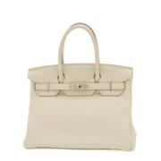 Pre-owned Leather handbags Hermès Vintage , Beige , Dames