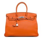 Pre-owned Leather handbags Hermès Vintage , Orange , Dames